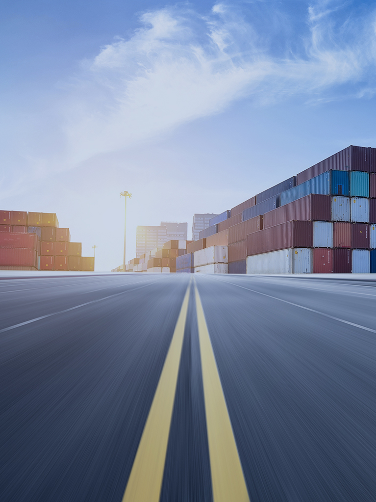 A road headed to a cargo container port. 